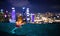 Children swimming in roof top outdoor pool on family vacation in Singapore. City skyline from infinity pool in luxury hotel. Kids