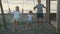 Children swing on a swing in the street at sunset.