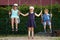 Children on a swing. Three beautiful little children swinging on swings on playground with smile on sunny summer day.