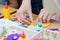 Children at the table do needlework and draw. children at a lesson of the fine arts do hand-made articles of paper