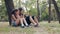 Children with tablet pc outdoors. Girl and boy on grass with computer