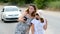 Children take a selfie on a mobile phone while standing on the road, not noticing the danger. Two girls are photographed on the