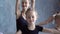 Children and teacher at the ballet school. Beautiful ballerinas in black tutus at a ballet lesson. Lovely girls dance at