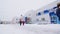 Children with teacher walk along snowy kindergarten yard