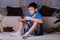 children, technology, internet communication and people concept - boy with smartphone texting message or playing game at home