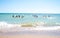 Children and teenagers swimming in the sea at summer camp