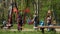 Children with their mothers, swinging in the park