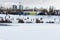 Children and their parents sledding from a snow slide in a city park with a frozen lake in Kiev  Ukraine