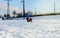 Children and their parents sledding from a snow slide in a city park with a frozen lake in Kiev  Ukraine