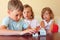 Children three together looking at model of house