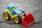 Children toy car excavator on asphalt