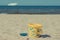 Children toys for relax or playing on sand at beach. Vacation time. Passengers ferry in background