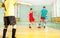 Children training football in school gymnasium