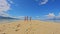 Children of the Triplet Sister play on the beach and in shallow water