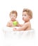 Children twins eating a green apple