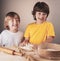 Children two brother and knead dough together