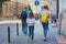 Children two girls daughters and father, tourists walking with backpacks and suitcase