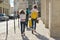 Children two girls daughters and father, tourists walking with backpacks and suitcase