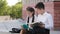 Children two schoolchildren hispanic little girl schoolgirl and boy pupil with book sitting outdoors kid opens diary