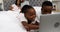 Children using laptop while couple smiling in background 4k