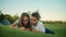 Children using smartphone in park. Siblings lying on green grass in meadow