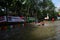 Children in the village play cheerful water slides on the river,