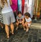 Children wait for shopping parents at street market in Paris, France