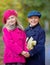 Children walking in beautiful autumn park on warm sunny fall day.