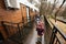 Children walking on terrace of one-storey modular houses in spring rainy forest