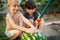 Children wash watermelon under the hose with hands