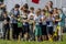 Children watching the battle of two teams. Young fans at sportive competition.