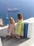 Children watching boats at Oia, Santorini, Greece