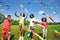 Children wave colorful ribbons in park together