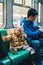 Children wearing coat and hood sitting near his father in the train that going to Zhaoping railway station in Alishan, Taiwan