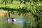 Children wild swimming in nature, in the River Chess at Chorleywood, Hertfordshire UK, during the coronavirus lockdown.