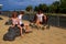 Children and women sit bowing their heads on sculptures of floating hippos. Anapa.