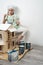 Children at work: The girl neatly paints the facade of the doll house with a small tassel in white.