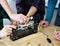 Children work in the training center on wood processing machines. Education in Fablab.