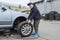 Childrens auto mechanic changes the wheel on a car. Replacing wheels on a car