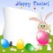 Childrens card for Easter with painted eggs and rabbit on floral meadow. Place for text