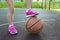 Childrens feet and a basketball ball close-up. Healthy lifestyle and sport concepts