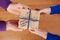 Childrens hands and daddy hands holding a gift or present box with kraft paper and tied blue ribbon tag on Happy fathers day