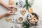 Childrens hands hold a cup of cocoa. Christmas gingerbread cookies, dried apples, spruce branches. Light background. Top view