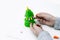 Childrens hands mould a fur-tree from plasticine