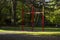 childrens high swing in the summer city park.