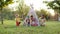 Childrens Holiday. Five Children Play Indians. Three Boys And Two Girls Are Sitting In Tent Outdoors With Painted Faces