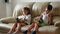 Childrens hugging a kittens. Girl and boy with cats siting on the sofa