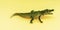 Childrens rubber toy green crocodile alligator on yellow background