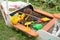 Childrens sandpit in the form of a boat with scattered bright toys.