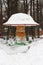 Childrens swing carousel seat in the snow, bright colorful attraction under the snow, winter amusement park no people